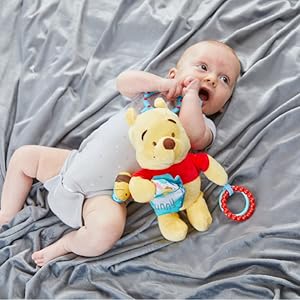 baby playing with winnie the pooh activity toy